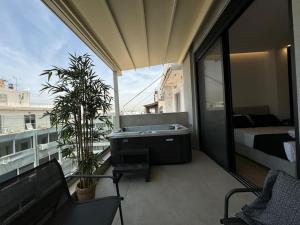 a balcony with a tub and a bed on a building at BlueMotion - CruiseNest 6Β in Piraeus