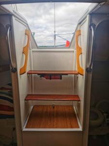 a small room with a bench in a boat at seuls à bord dans le golfe hebergement atypique in Porto-Vecchio +4 photos