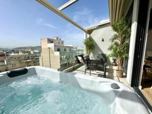 a bath tub sitting on top of a balcony at BlueMotion - CruiseNest 6Α in Piraeus