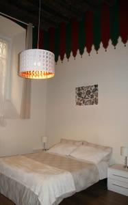 a bed in a room with a lamp on top of it at Le Muse in Brescia
