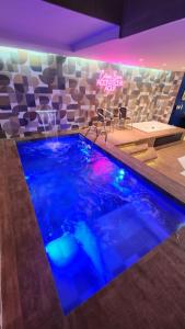 a swimming pool with blue water in a room at Amaretto Motel - Adults Only in Arcoverde