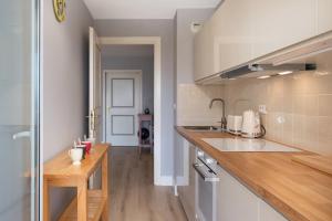 a kitchen with a sink and a counter top at BEAUSEJOUR - Splendide 2 pièces - Piscine - Parking - Vue mer in Beausoleil +21 photos