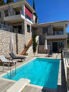 a swimming pool in front of a house at Lavender House 1 - Agios Nikitas in Agios Nikitas