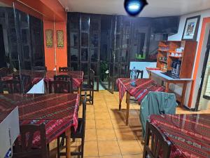 a restaurant with tables and chairs in a room at Mirador Backpackers B&B in Huaraz