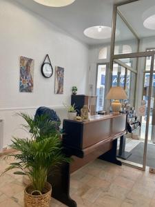a room with a grand piano in a store at Hôtel De Normandie in Amiens