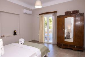 Posteľ alebo postele v izbe v ubytovaní Mellow mood Tinos Town