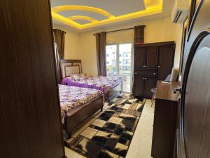 a bedroom with two beds and a window at Ksara Zahle - Luxurious two bedroom apartment in Zahlé