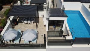 an aerial view of a house with a swimming pool at Vila Ibrahimovic Vodice in Vodice