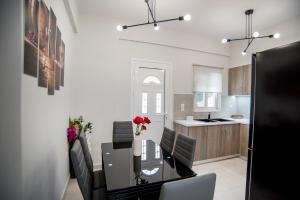 a dining room and kitchen with a table and chairs at Terra Kotta 2 in Vrachos +28 photos