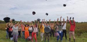 a group of people throwing graduation hats in the air at Chateau de la Vieille Chapelle in Lugon et l’Ile du Carney