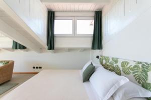 a bedroom with a bed and a window at Harvey Suites Hotel & Residence in Lido di Jesolo