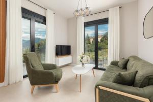 a living room with a couch and two chairs and a tv at NM Palace Apartment in Kotor +14 photos
