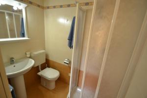 a bathroom with a toilet and a sink and a shower at Villa Poli in Bibione