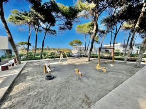 a playground with a swing set and trees at Appartement LUXUEUX 1 plage SFIHA AL HOCEIMA in Ajdir