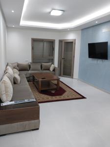 a living room with a couch and a coffee table at Appartement Miftah Sahill 1 haut Standing in Agadir
