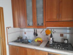 a kitchen with a sink and a stove and cabinets at Casa Palombara - Baschi in Baschi