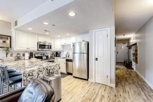 a kitchen with white cabinets and a stainless steel refrigerator at Elegant Escape in Park City