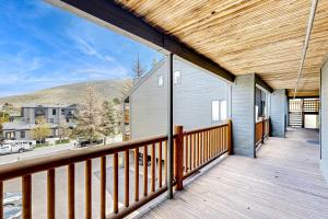 a balcony with a wooden railing and a house at Elegant Escape in Park City