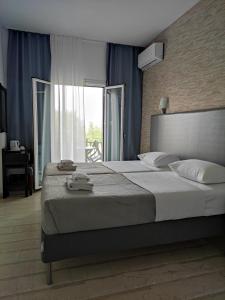 A bed or beds in a room at Tina Hotel