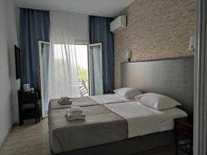 A bed or beds in a room at Tina Hotel