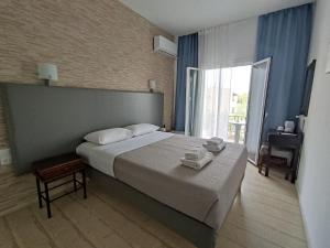 A bed or beds in a room at Tina Hotel