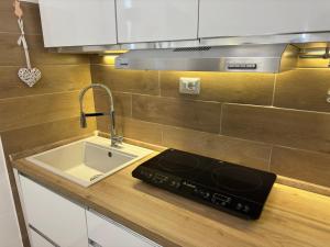 a kitchen counter with a sink and a stove at Il Sogno di Sperlonga in Sperlonga