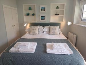 a bedroom with a bed with towels on it at Palomar in Falmouth
