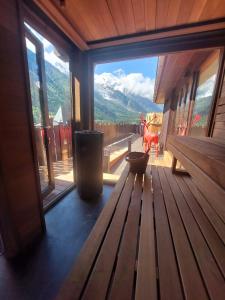 a room with a bench and a view of a mountain at Park Hotel Suisse & Spa in Chamonix +230 photos