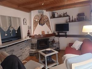 a living room with a couch and a fireplace at Peña Telera Petfriendly - Arafita Apartamentos in El Pueyo de Jaca