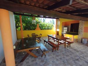 a dining room with tables and a pool table at Casa Grande in Camocim