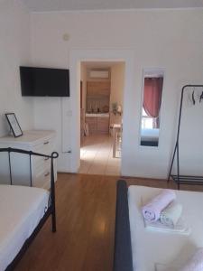 a bedroom with two beds and a room with a hallway at Apartmani Fani 2 min walking from sea in Orebić