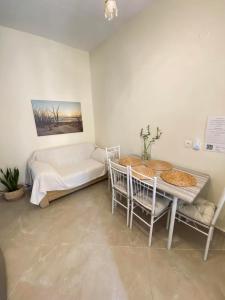 a living room with a couch and a table at Backyard houses in Toroni