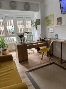 an office with a desk with a computer on it at Pension Angelines, Sneuu Hostel Santander in Santander