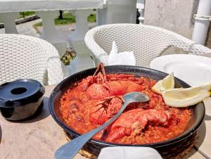a pan of food sitting on a table at Pension Angelines, Sneuu Hostel Santander in Santander