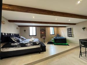 a living room with a large bed and a table at Le Cocon SPA lune de miel in Lunel +29 photos