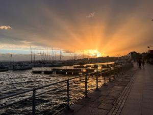 a sunset over a marina with boats in the water at Pension Angelines, Sneuu Hostel Santander in Santander