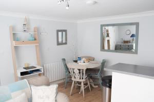 a small dining room with a table and chairs at Palomar in Falmouth