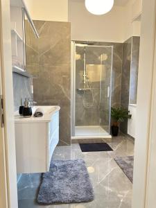 a bathroom with a shower and a sink at City Suite Drita in Alsdorf
