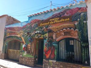 a mural on the side of a building at Corral de Piedras in Humahuaca