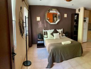 a bedroom with a large bed and a mirror at ApartaUnMomento y Desconecta! in Estepona