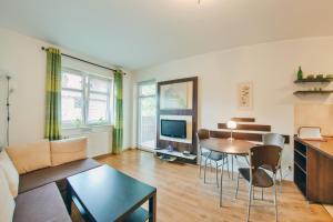 a living room with a couch and a table at Apartamenty Sun & Snow Rezydencja Parkowa in Szklarska Poręba