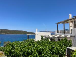 a white house with a view of the water at Ravishing View, Zastani Houses in Marmari