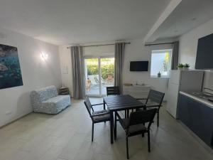a kitchen and living room with a table and chairs at ***Villa Prestige**** in Capoliveri