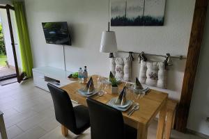 mesa de comedor con sillas y mesa de madera en Ferienwohnung Wera -am Bikepark-Sauna, en Winterberg