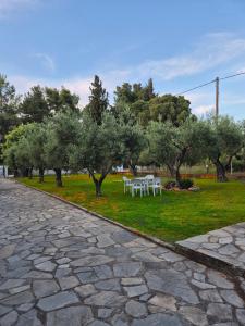 a picnic table in a park with trees and grass at GeoVilla Green & Blue 2 - Pefkochori in Pefkochori +51 photos