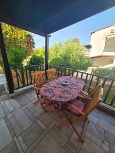 a table and two chairs on a patio with a table and chairs at GeoVilla Green & Blue 2 - Pefkochori in Pefkochori