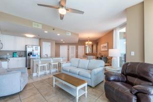 a living room with a couch and a table at Lighthouse Condominiums in Gulf Shores +53 photos