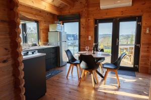 a kitchen and dining room with a table and chairs at Le Chalet du Crescent in Saint-Germain-des-Champs