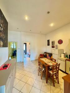 a kitchen and living room with a table and chairs at Al Civico 15 in Grosseto