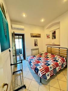 a bedroom with a bed with a colorful quilt at Al Civico 15 in Grosseto